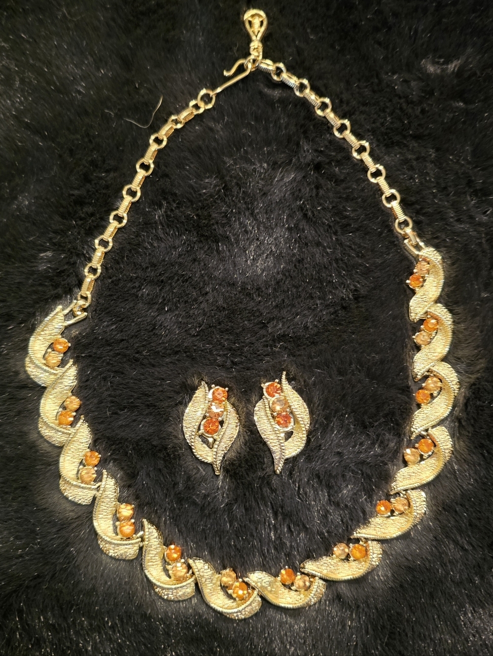 Vintage/antique necklace and earring set. Leaf pattern with amber rhinestones
